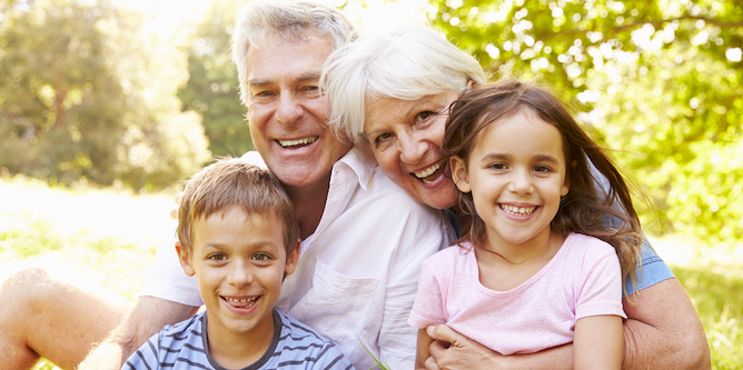 Two grandparents hugging two grandchildren